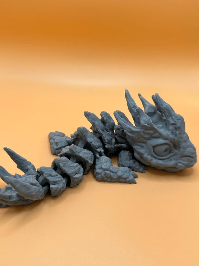 Articulated stone baby dragon
